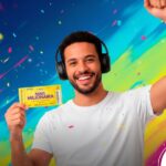 Homem sorridente segurando volante simbólico da mais milionária