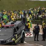 Brasilia (DF) 08/01/2023 - Golpistas invadem prédios públicos na praça dos Três Poderes. Na foto, carros da Polícia Legislativa  são depredados por vândalos em frente ao Congresso Nacional.