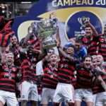 Soccer Football - Copa do Brasil - Final - Second Leg - Atletico Mineiro v Flamengo - Arena MRV, Belo Horizonte, Brazil  - November 10, 2024 Flamengo's Gerson, Bruno Henrique and teammates celebrate winning the Copa do Brasil with the trophy REUTERS/Cris Mattos