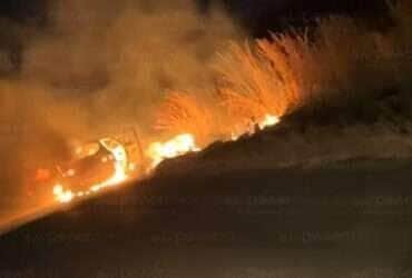 Fogo consumiu completamente o veículo e se espalhou pela vegetação às margens da rodovia; Corpo de Bombeiros controlou as chamas e não houve vítimas