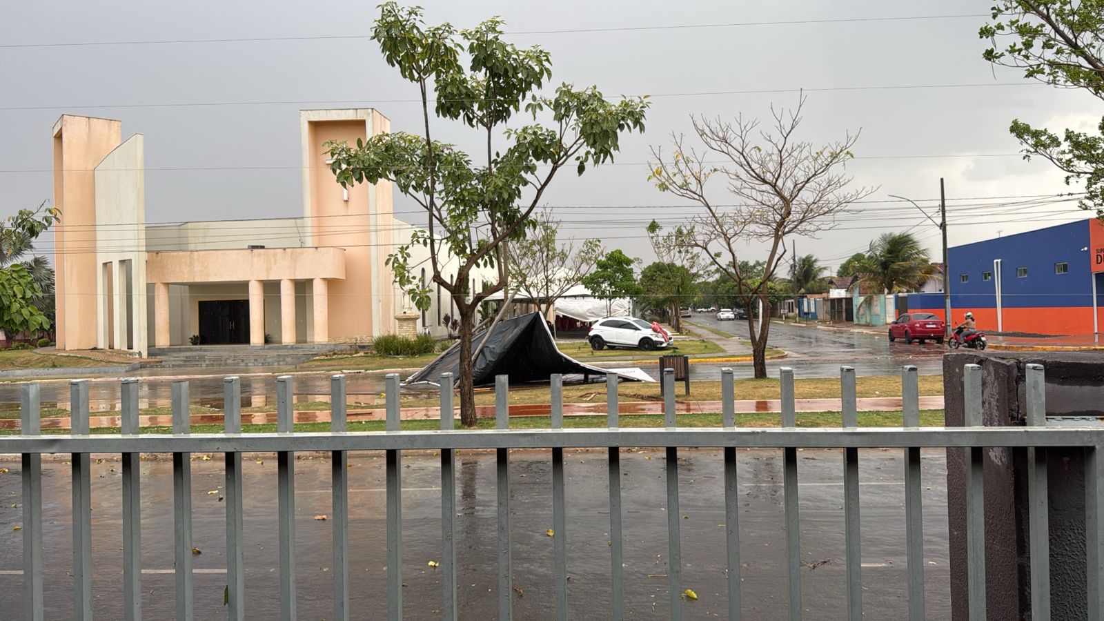 Muro de empresa desaba e ventania provoca estragos; moradores registram veículos atingidos por pedras de gelo