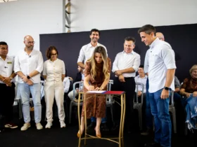 Assinatura do convênio com autoridades ou imagem aérea do bairro Santa Rosa, em Campo Verde.