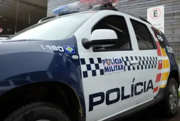 Viatura da PM estacionada em pátio em dia nublado