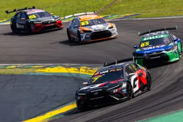 Carros da Stock Car em uma curva durante o grande prêmio.