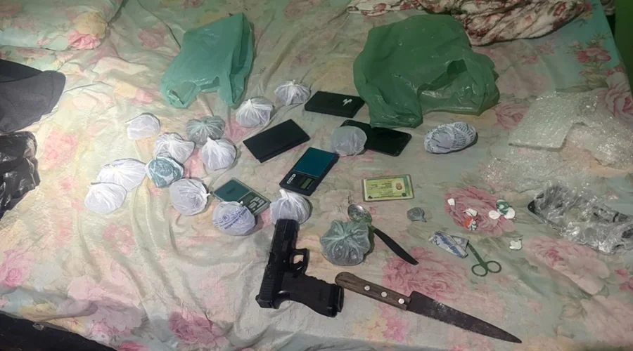 Objetos apreendidos em boca de fumo, contendo uma glock, uma faca e diversos pacotes com drogas