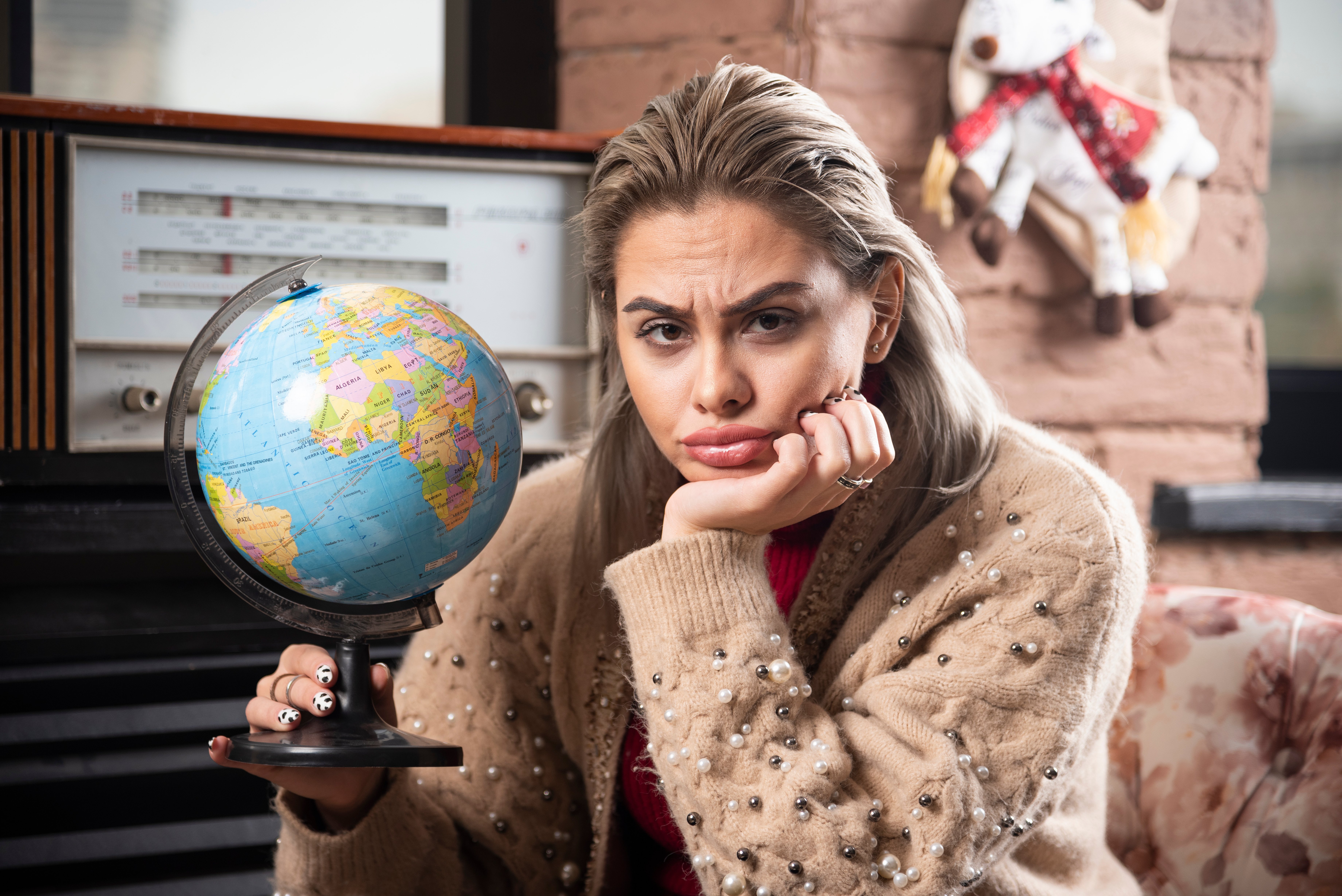 Portrait of beautiful lady holding a world globe